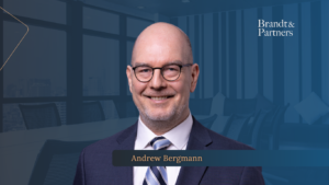 Business leaders reviewing a 100 day post acquisition plan in a modern office